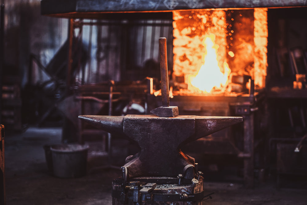 Anvil with glowing hot metal in a blacksmith workshop