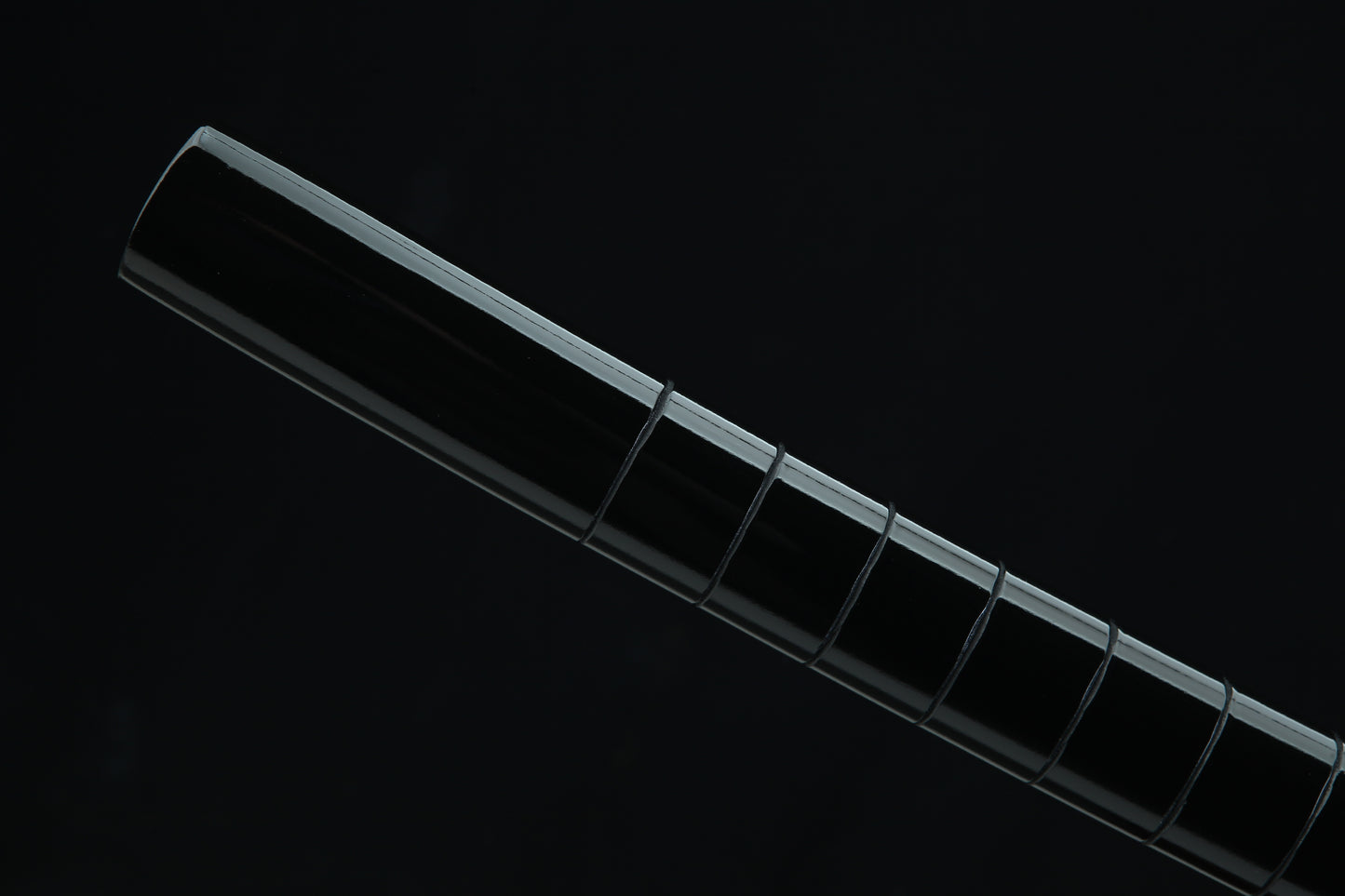 Black lacquered wooden saya scabbard of Jaryū Evil Dragon katana with black cord wrapping and traditional Japanese finish