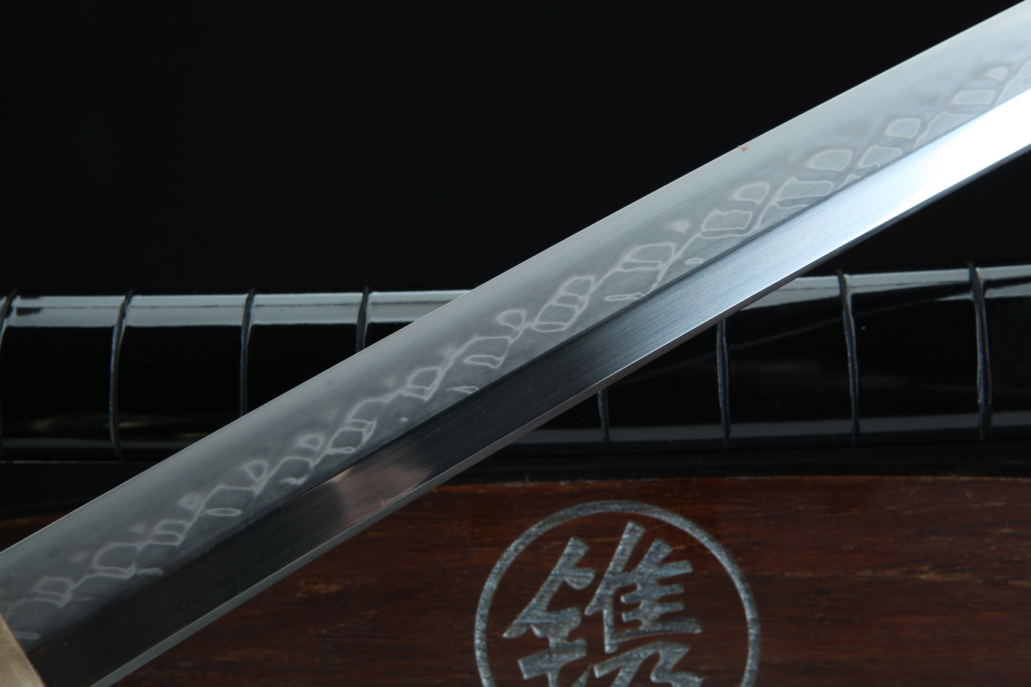 Clay-tempered 1095 carbon steel blade of Jaryū Evil Dragon katana displaying traditional Japanese sword forging techniques
