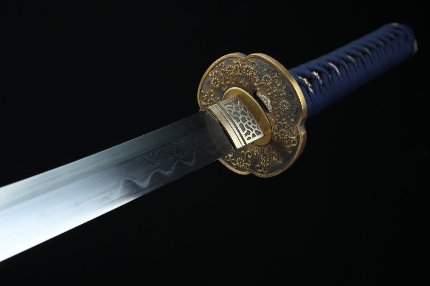 Bronze tsuba guard of Sōō katana featuring traditional Japanese metalwork complementing Damascus steel blad
