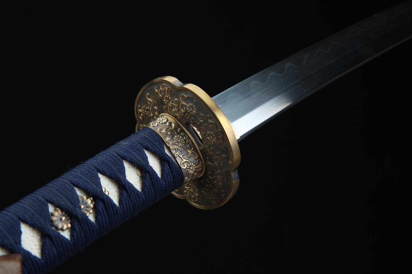 Bronze tsuba guard of Sōō katana featuring traditional Japanese metalwork complementing Damascus steel blad