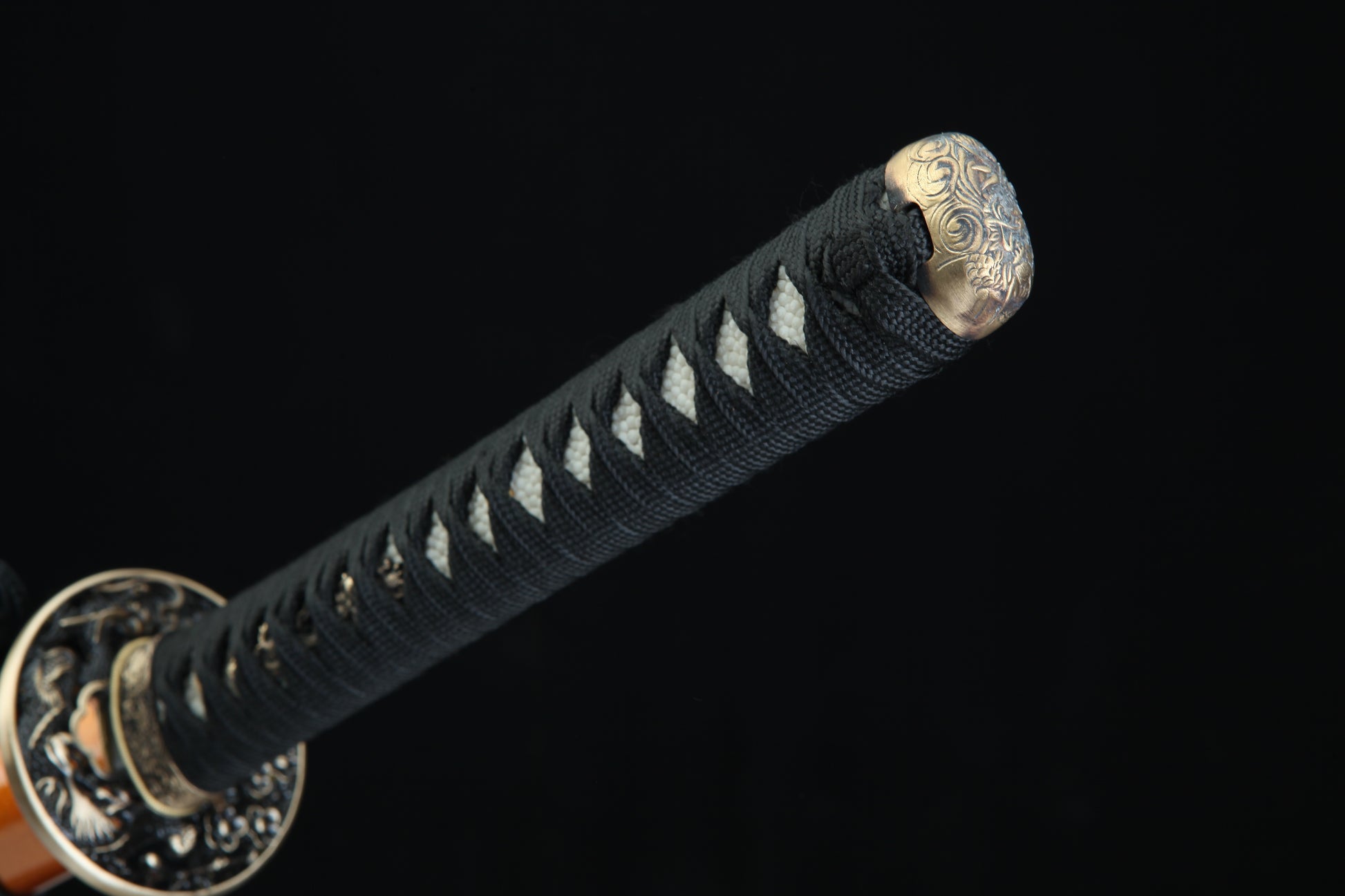 Black cord-wrapped tsuka handle of Fūrai katana with authentic fish skin samegawa and bronze menuki fittings
