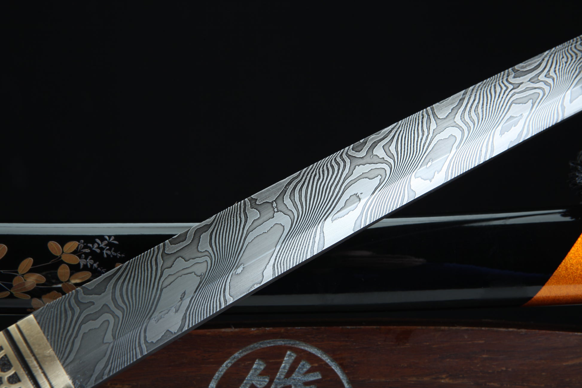 Close-up of a Damascus steel sword blade on a dark background