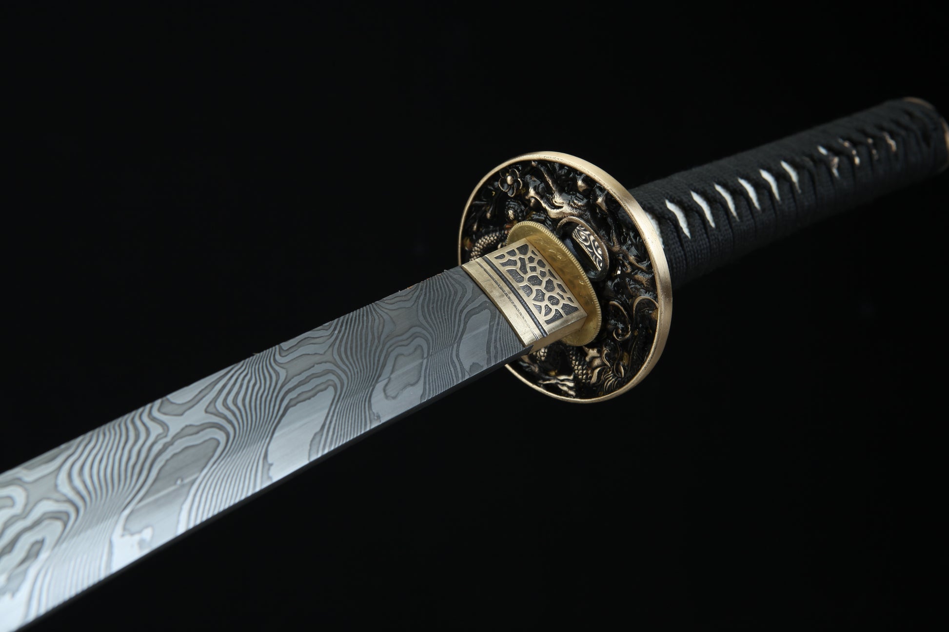 Bronze tsuba guard of Fūrai katana featuring traditional Japanese metalwork complementing Damascus steel blade