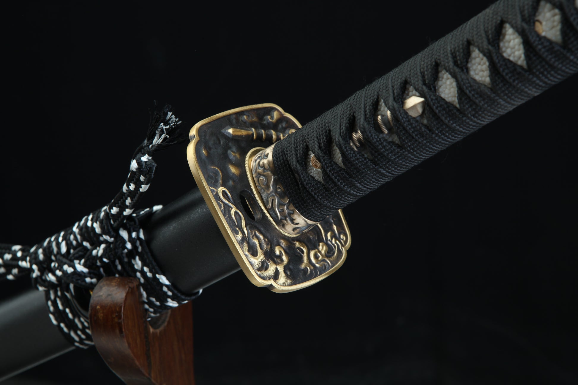 Aged bronze tsuba guard of Tenma katana featuring traditional Japanese metalwork with authentic patina finish