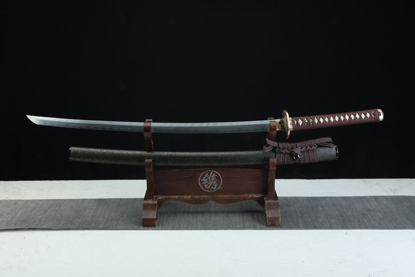 Sword on a wooden stand with a black background