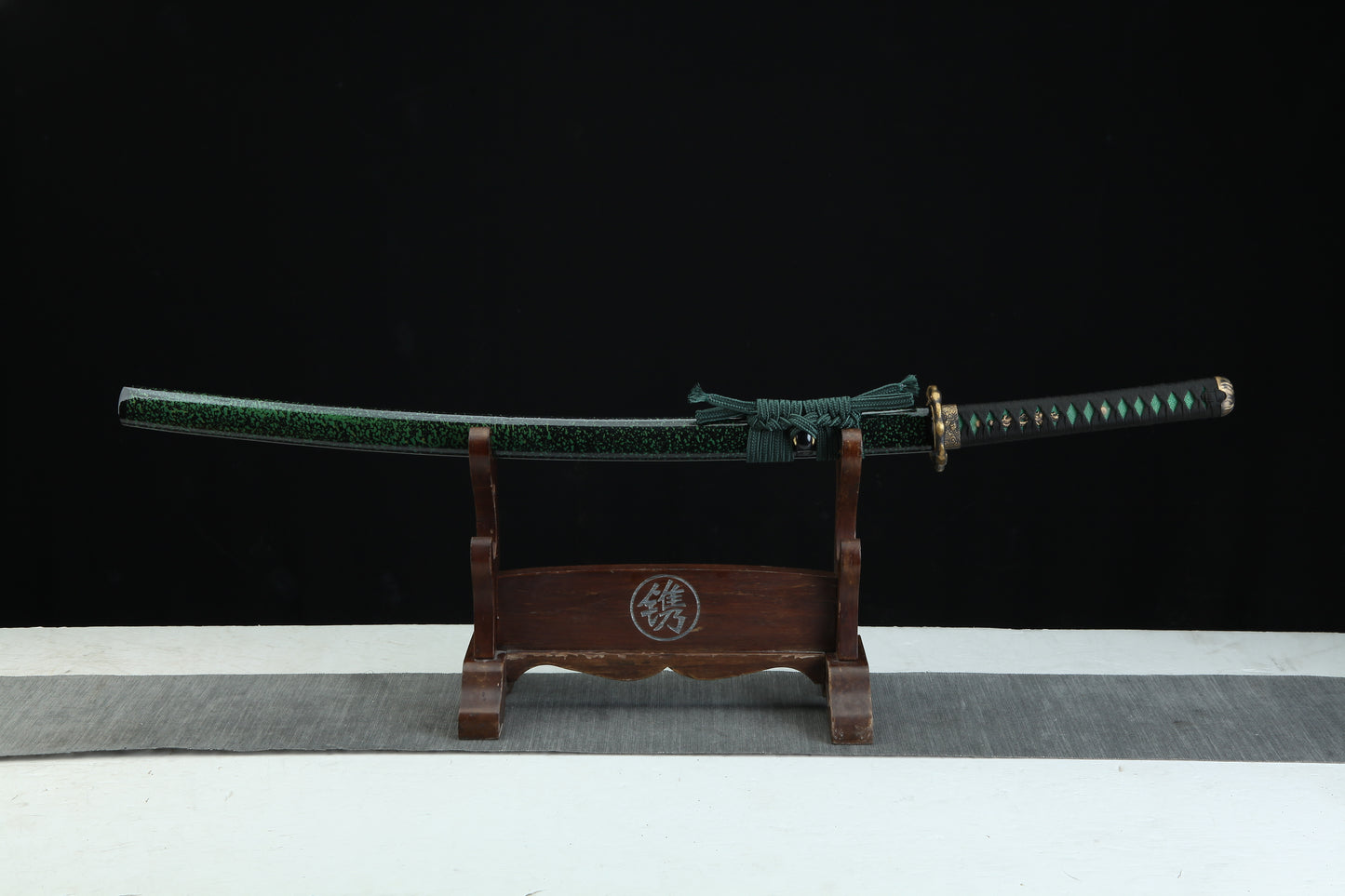 Sword on a wooden stand with a black background