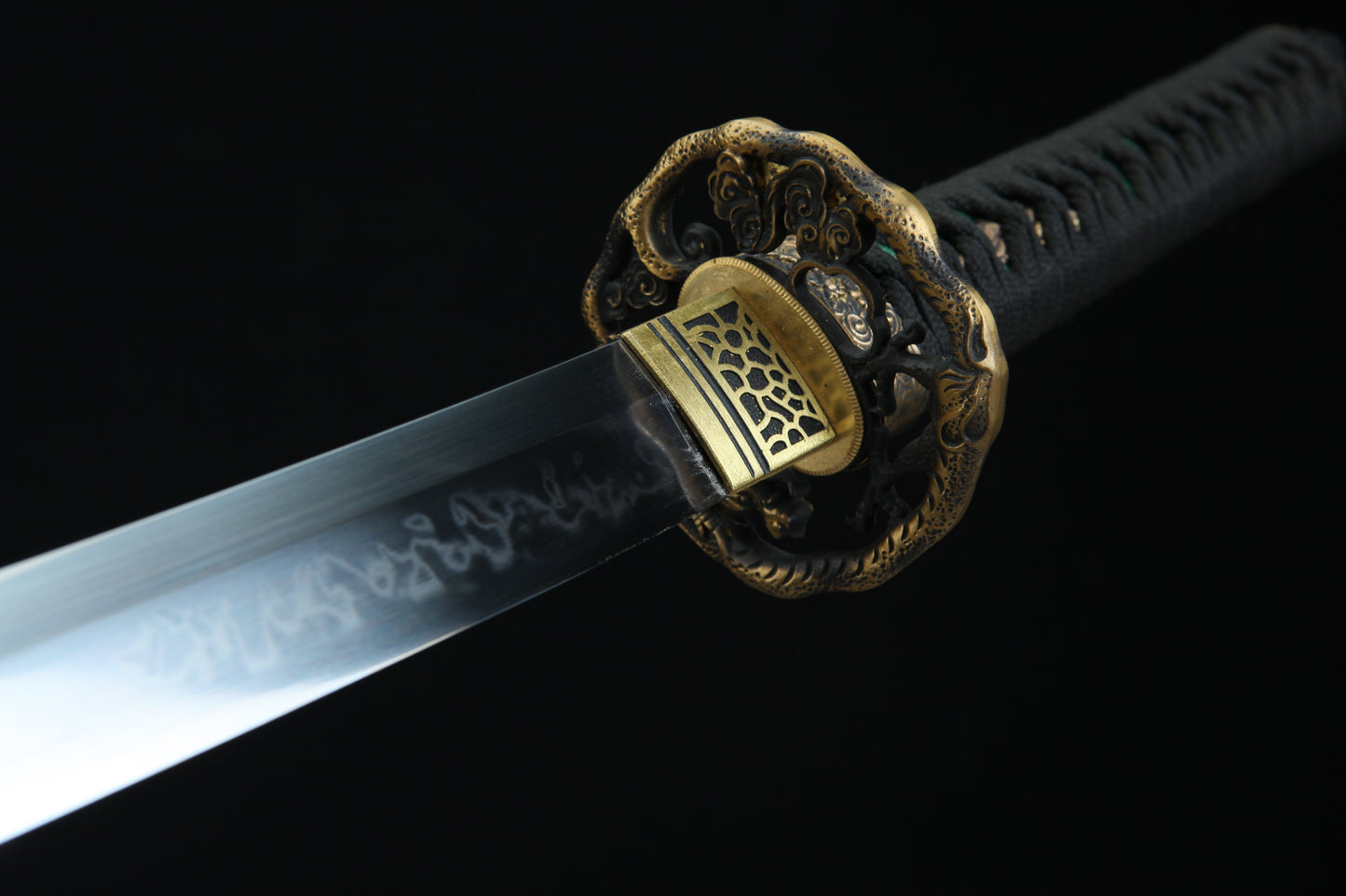 Close-up of a sword with a decorative hilt on a black background