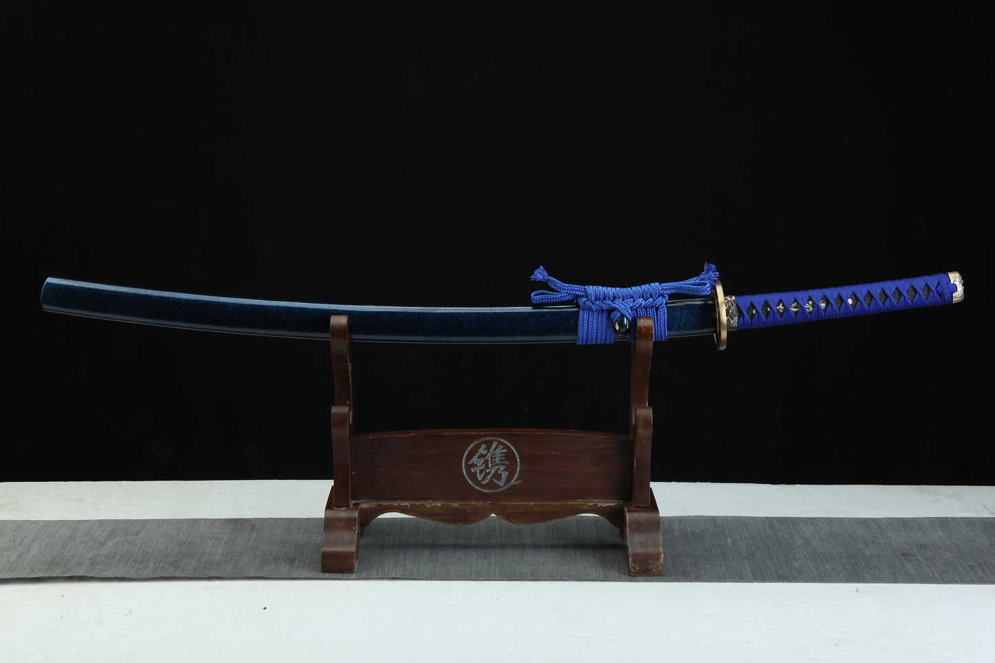 Sword on a wooden stand with a black background