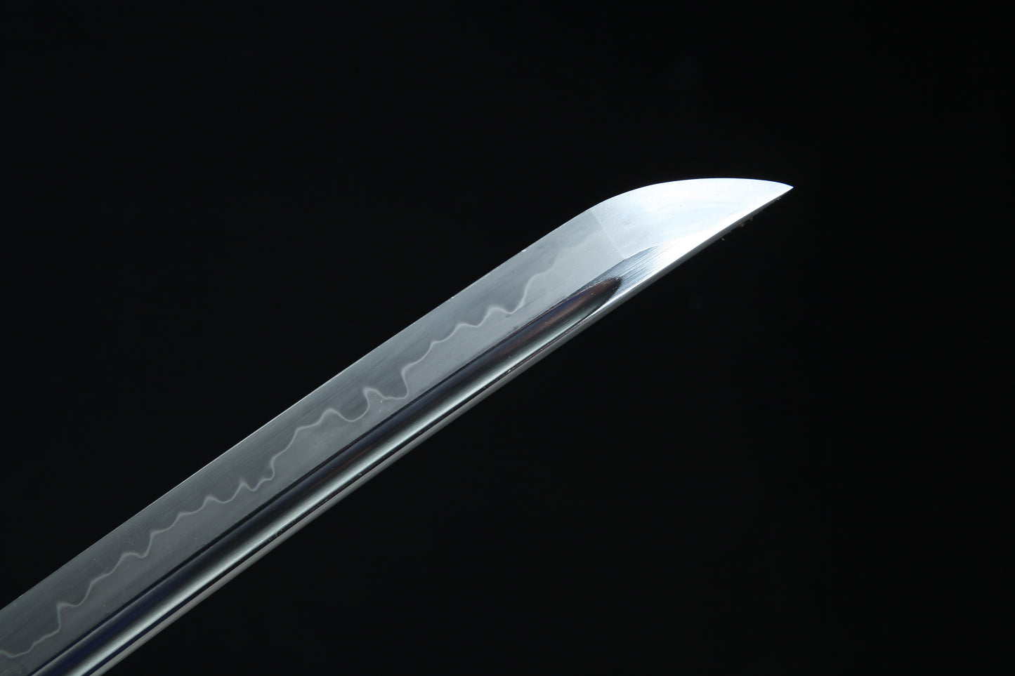 Sword blade with engraved patterns on a black background