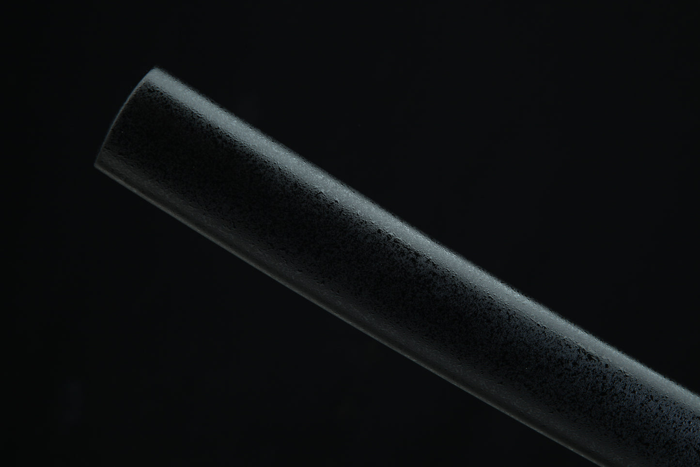 Black katana sheth t on a black background
