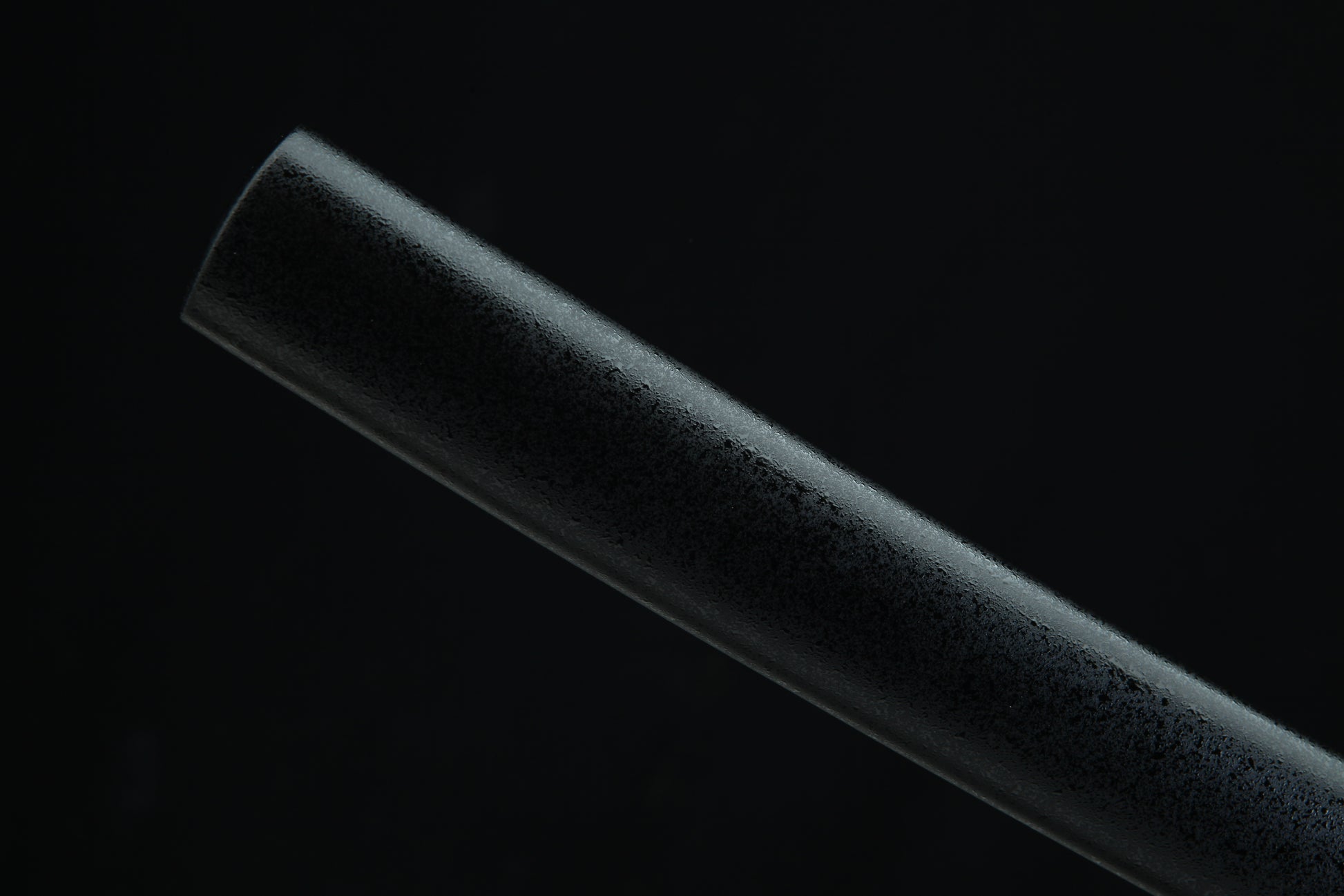 Black katana sheth t on a black background