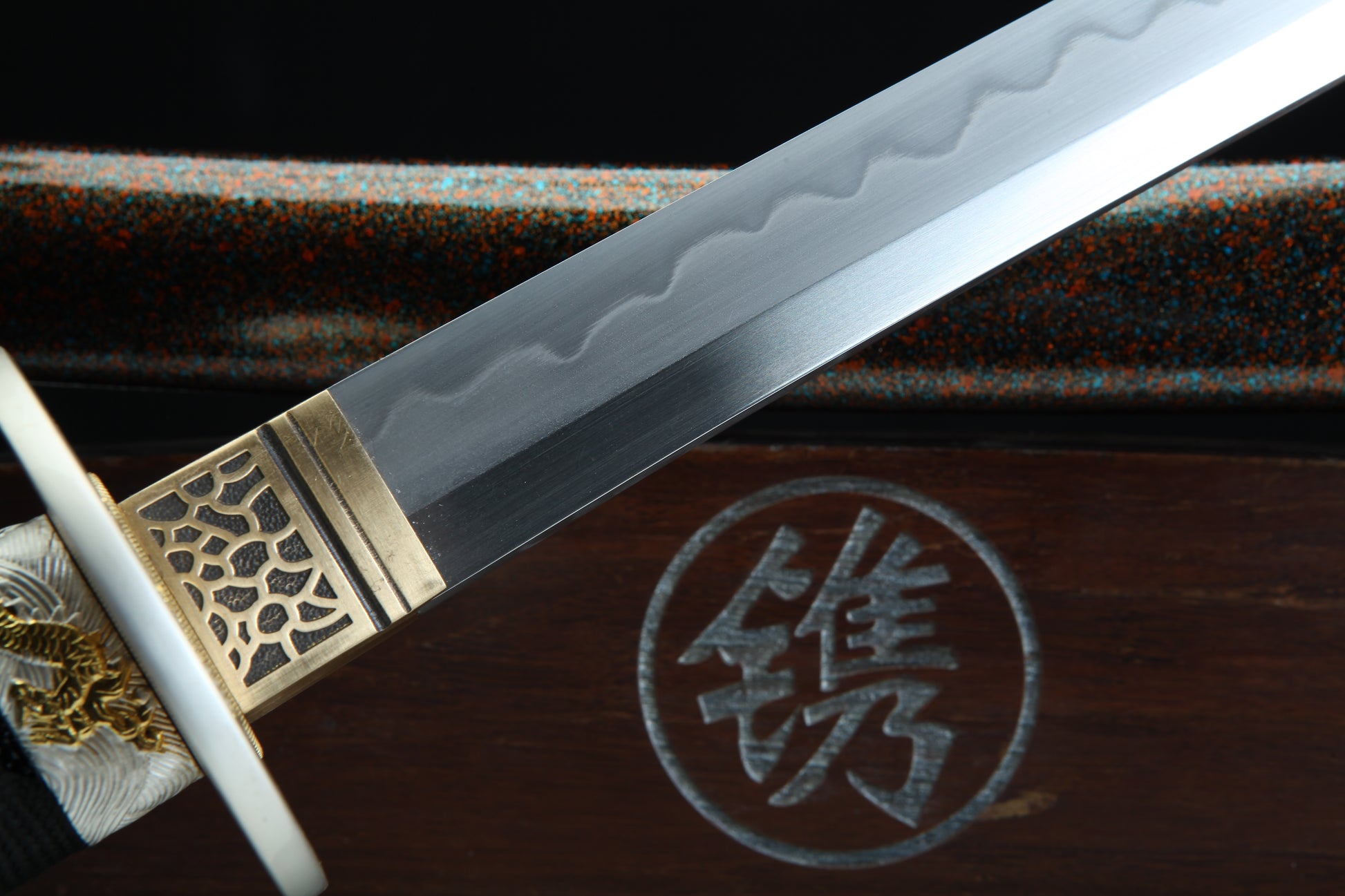 Sword with decorative hilt on a wooden surface