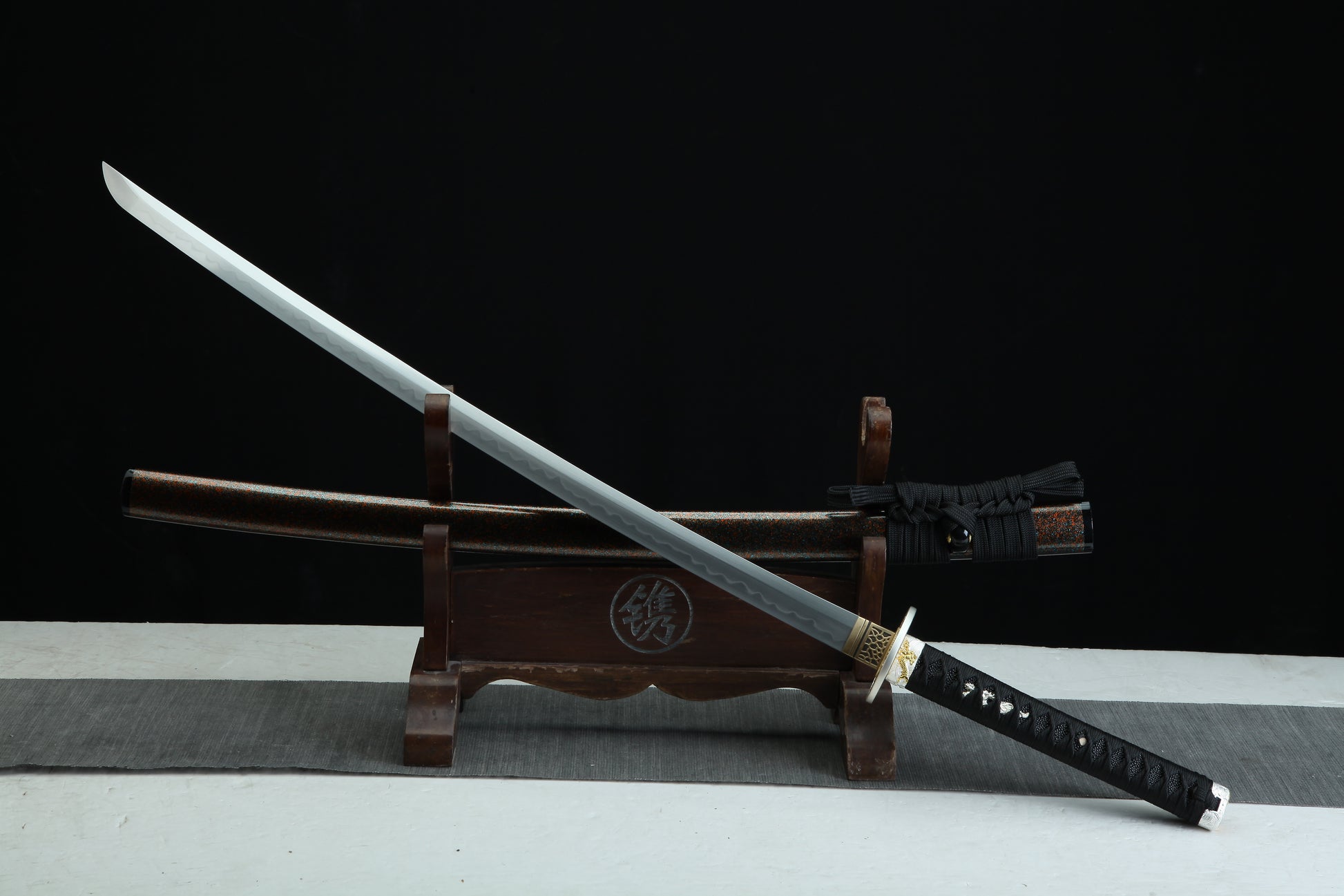 Sword on a wooden stand with a dark background