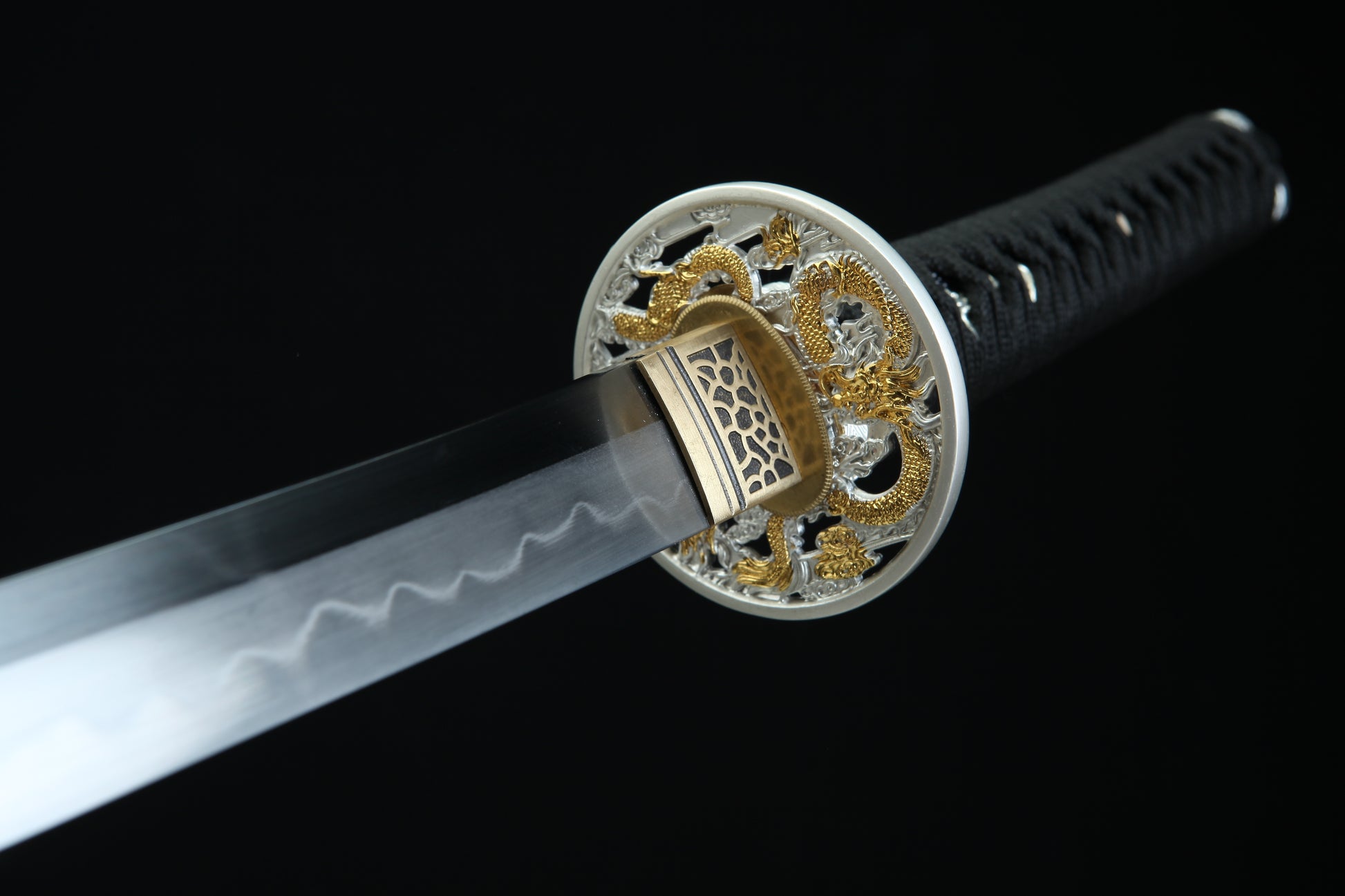Sword with decorative hilt on a black background