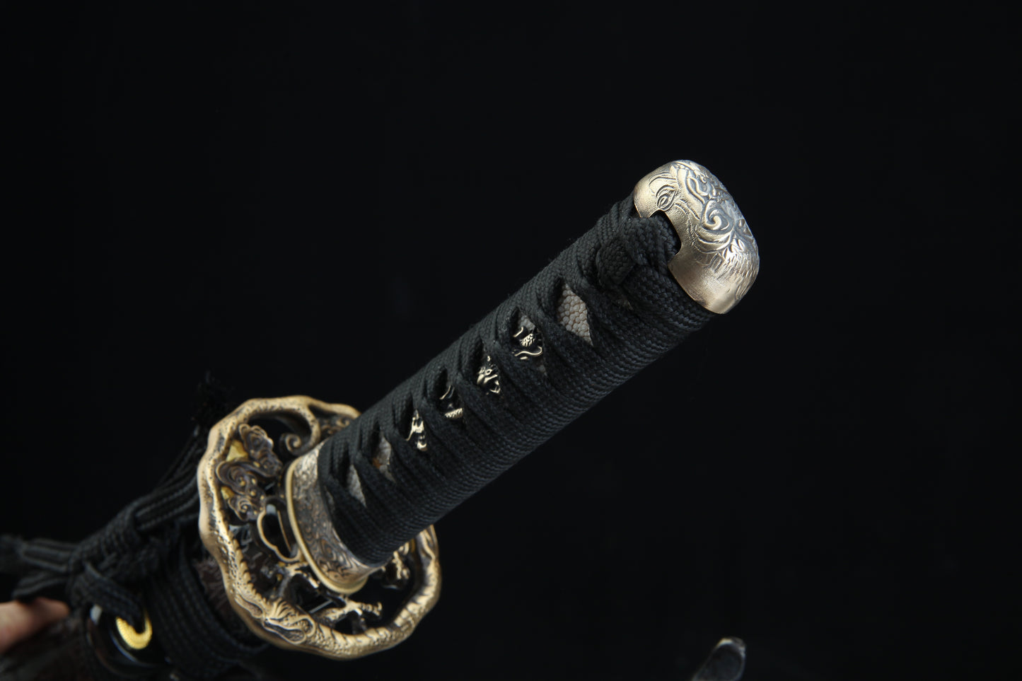Black cord-wrapped tsuka handle of Tengyaku tanto with authentic fish skin samegawa and bronze menuki details