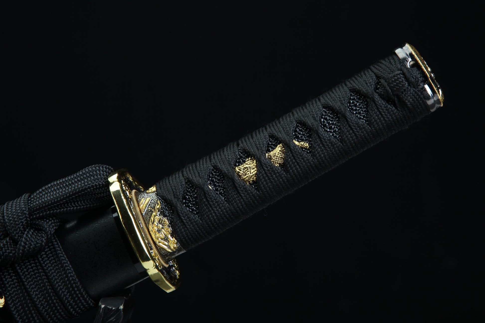 Black sword sheath with gold decorative elements on a black background