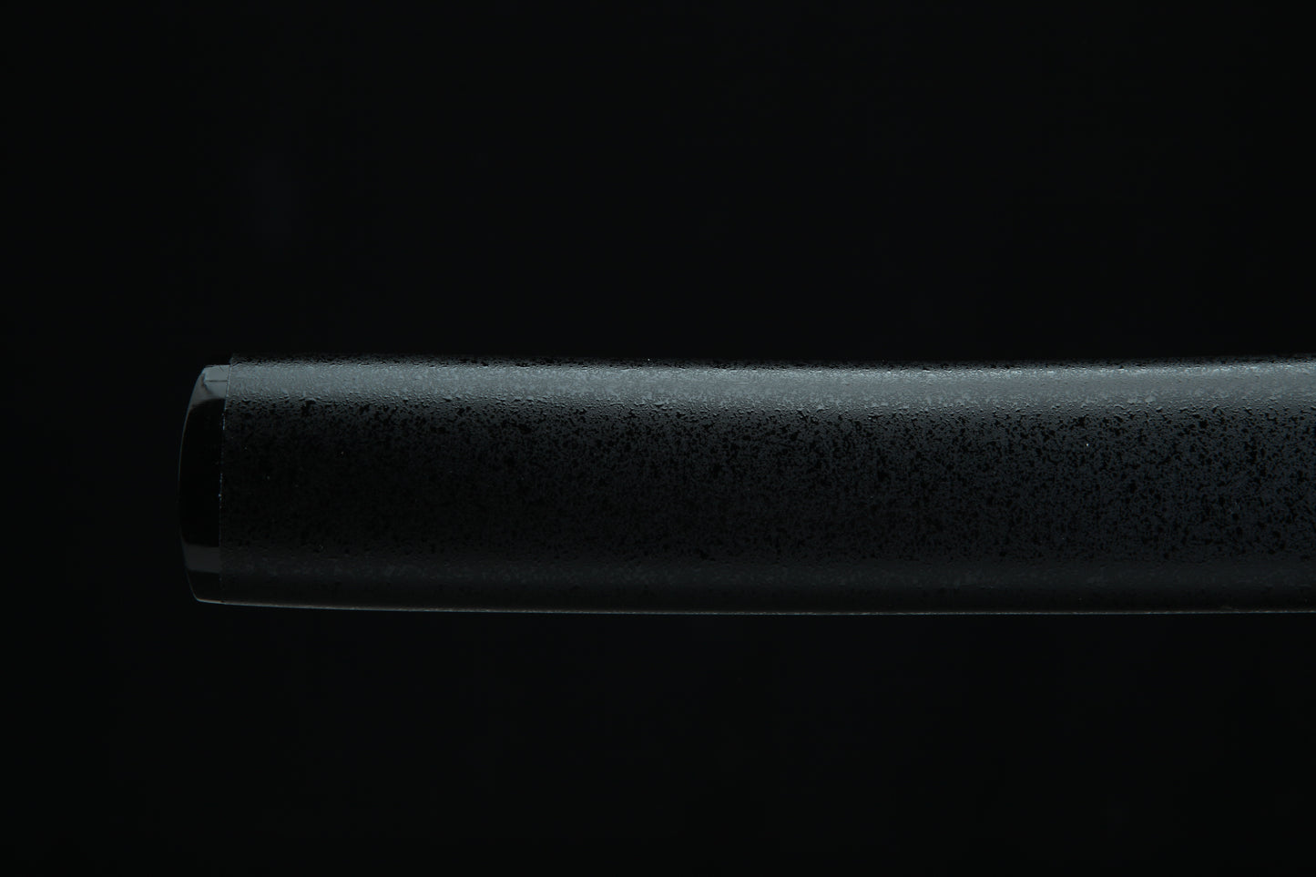 Black cylindrical Tanto Shealth on a black background