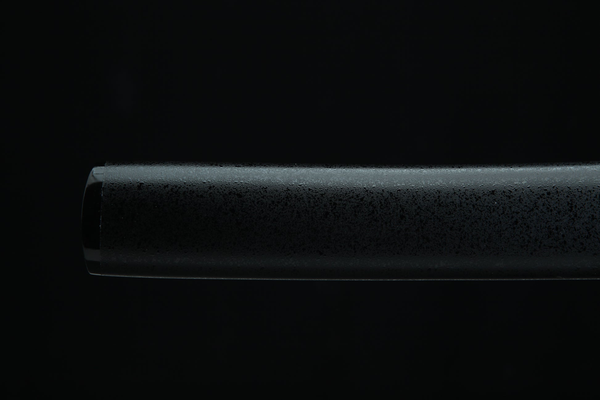 Black cylindrical Tanto Shealth on a black background