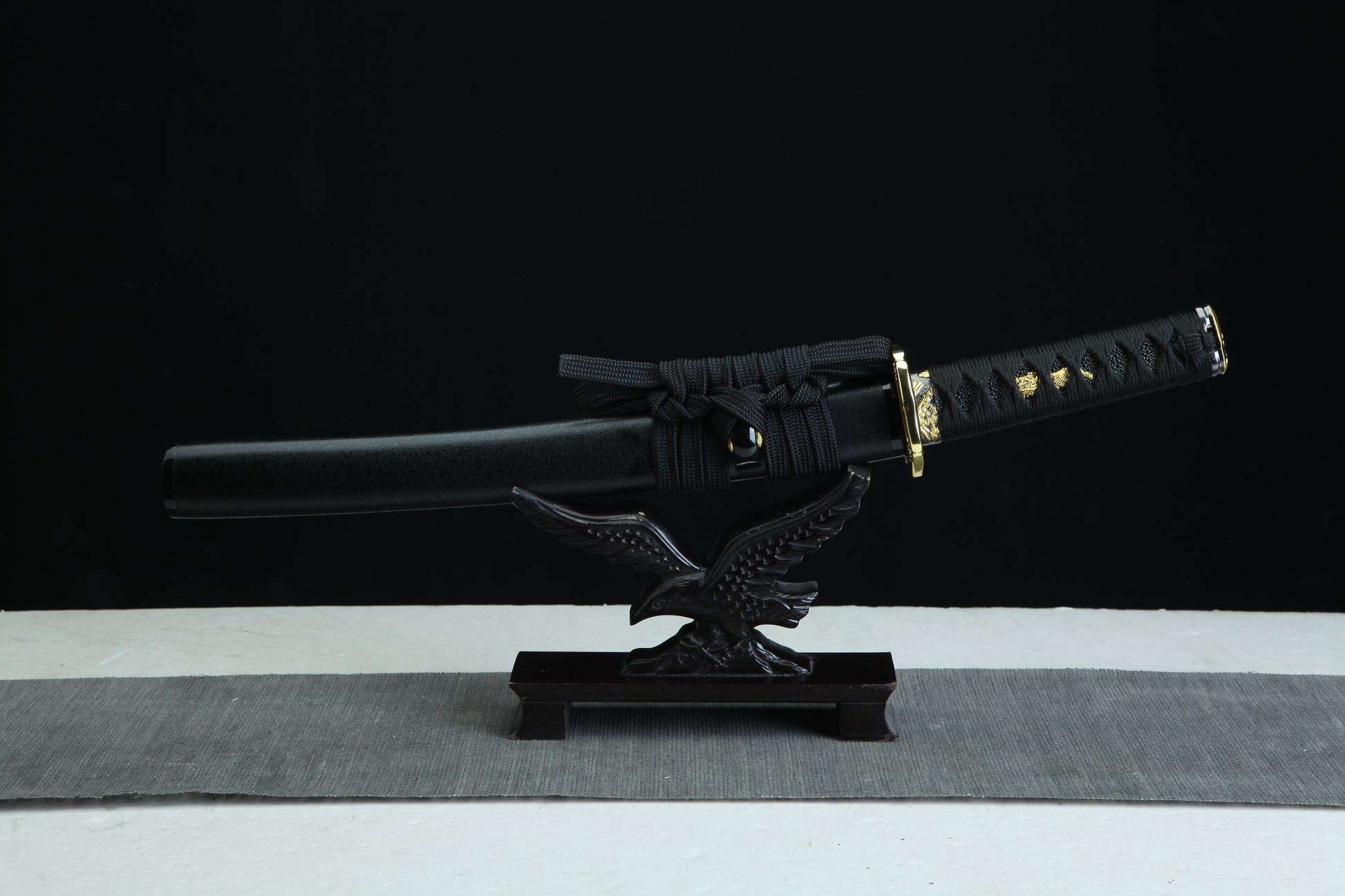 Sword on a stand with a black background