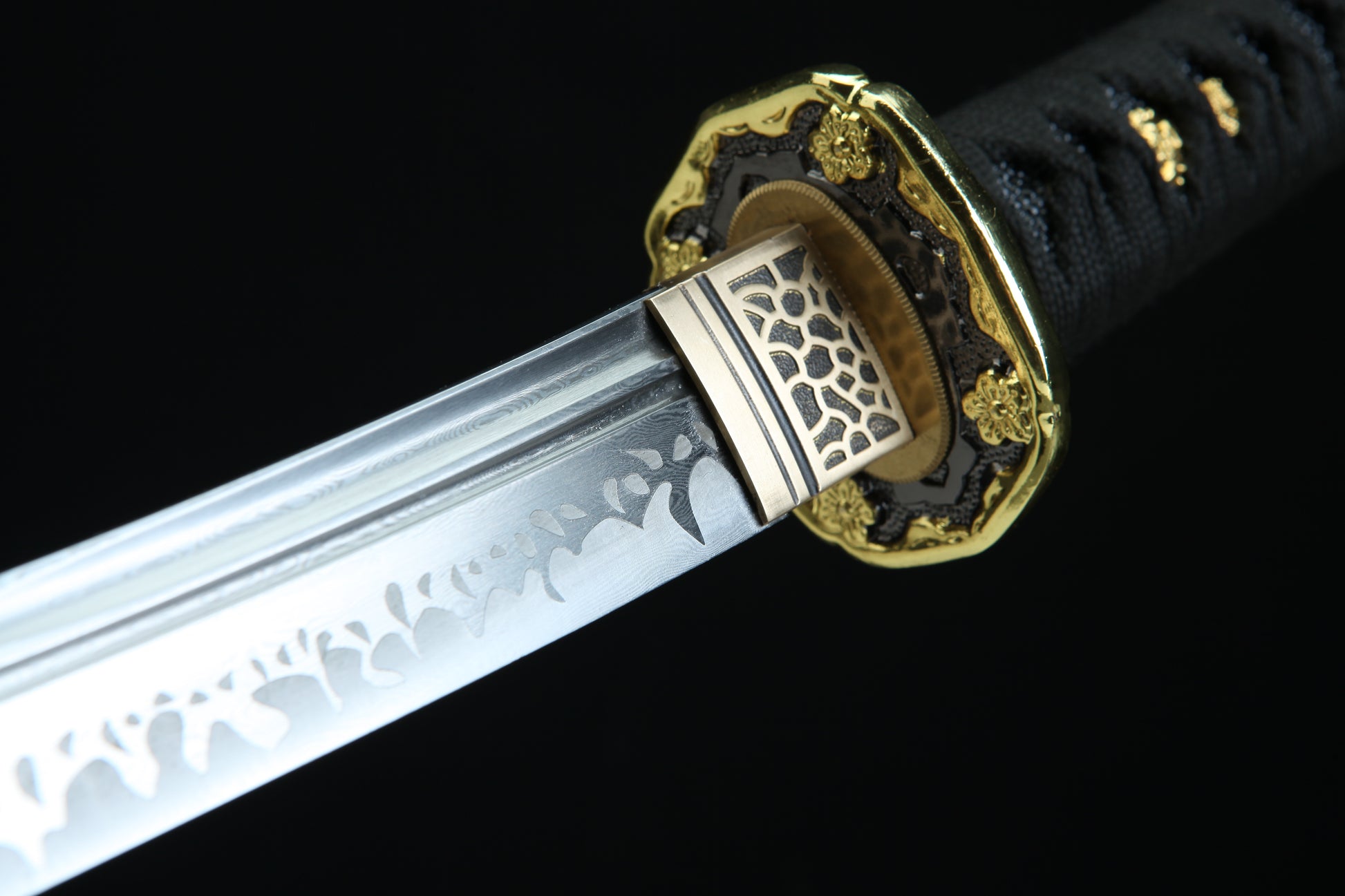 Sword with decorative hilt on a black background