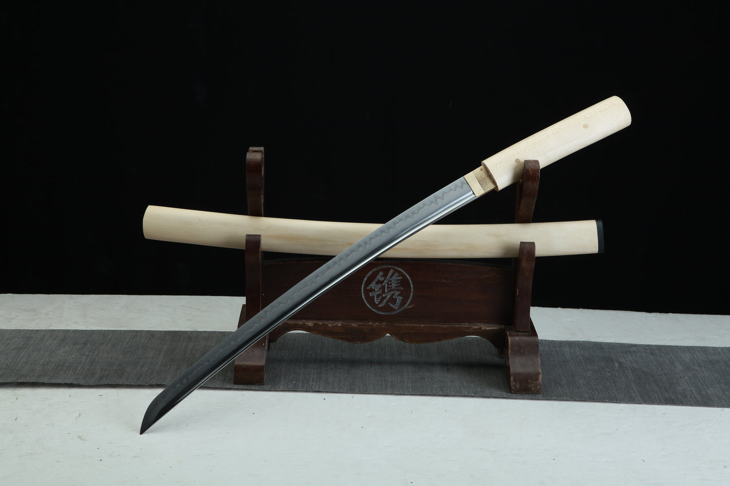 Sword on a wooden stand with a black background