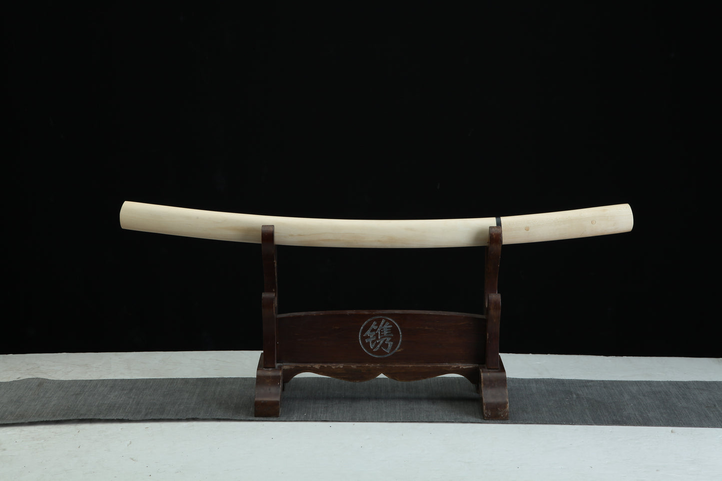 Sword sheath on a stand with a black background