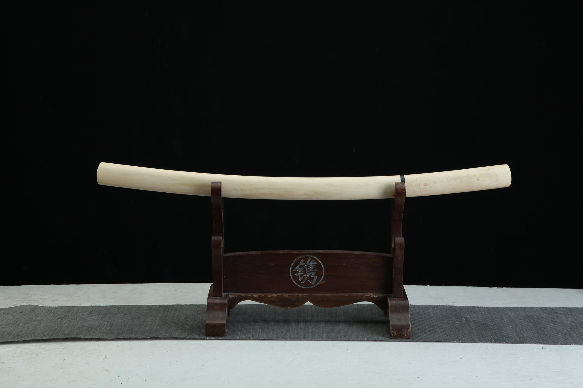Sword sheath on a stand with a black background