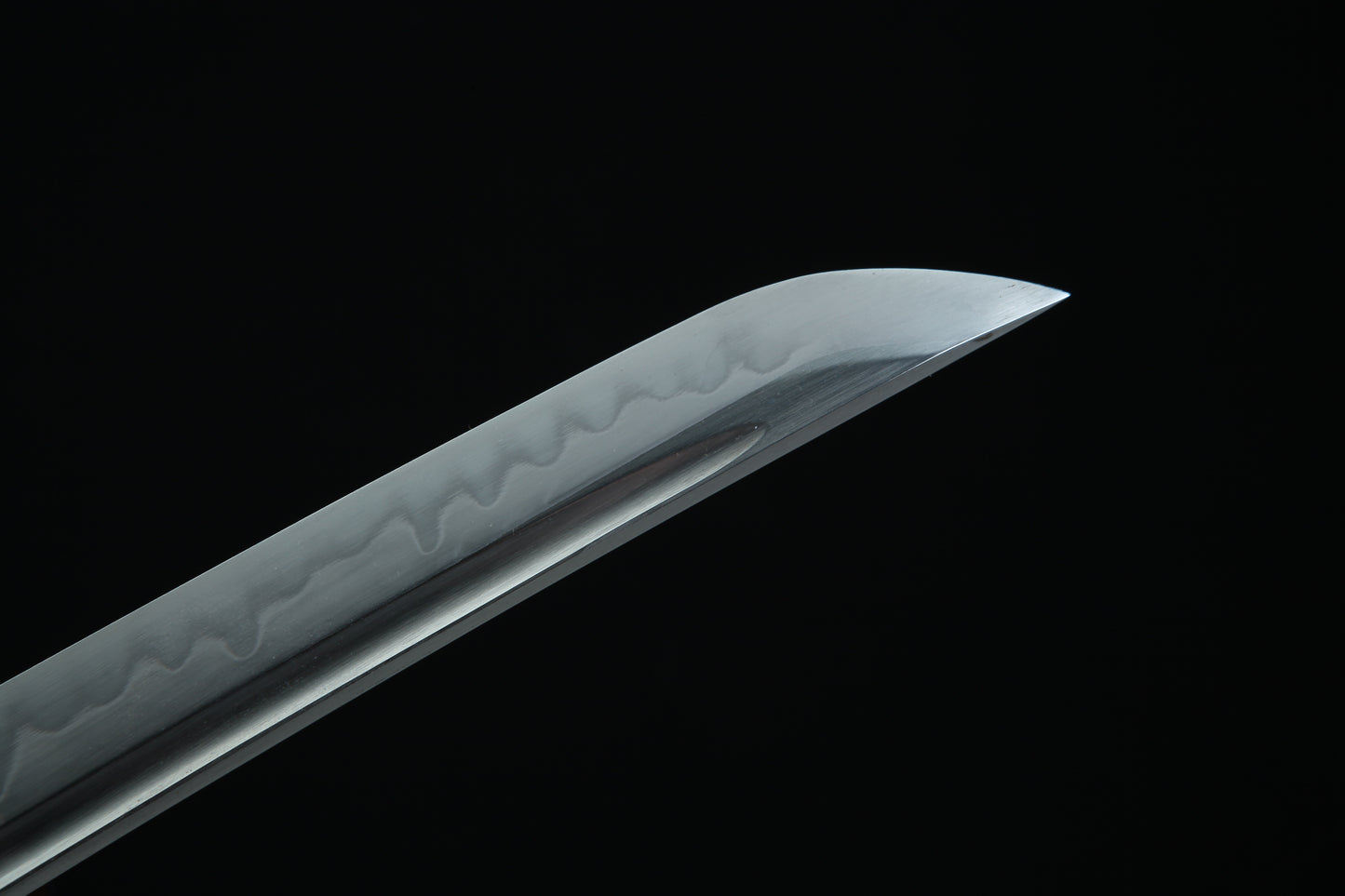Sword blade with intricate patterns on a black background