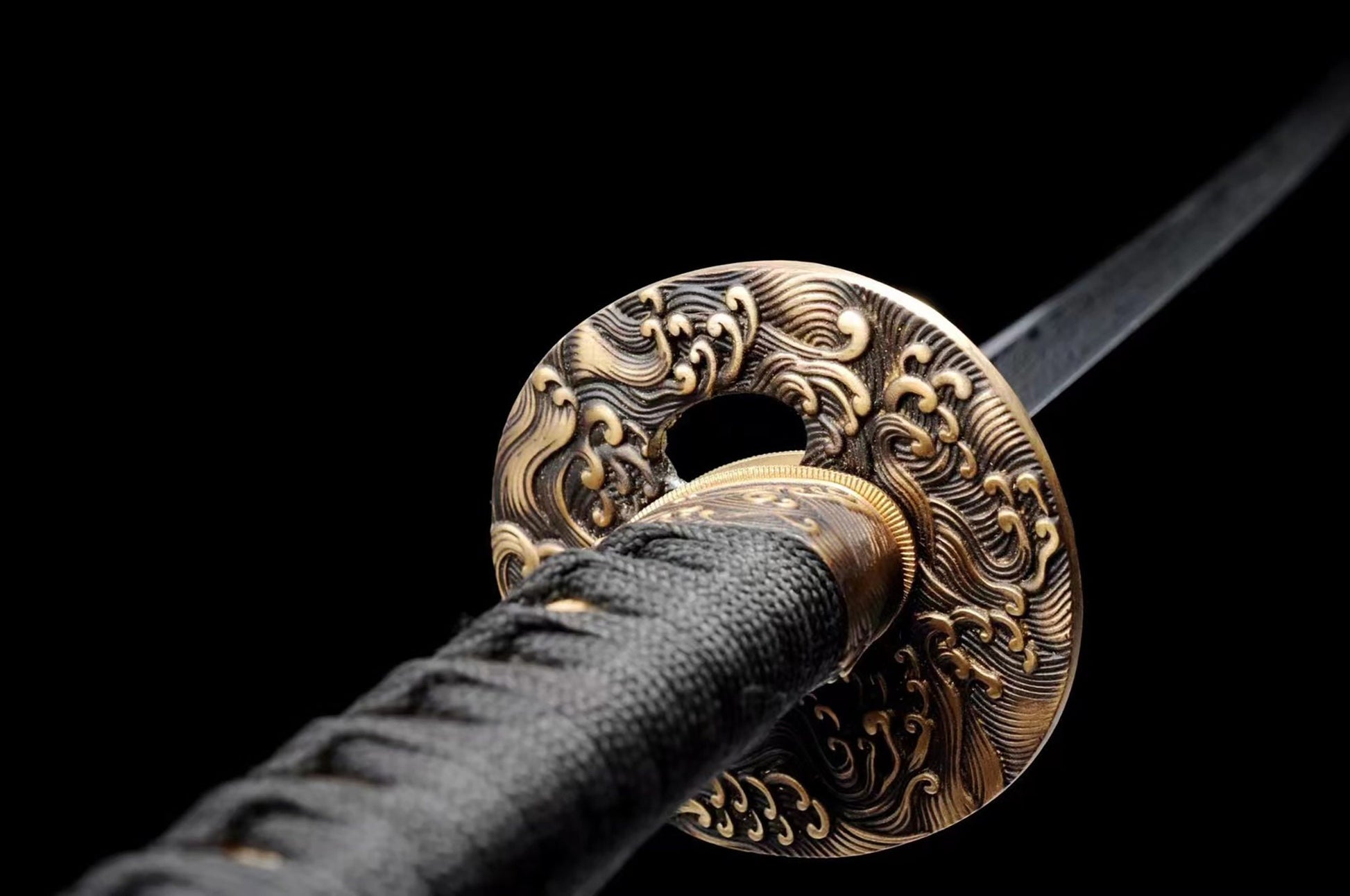 a black and gold sword with a black handle
