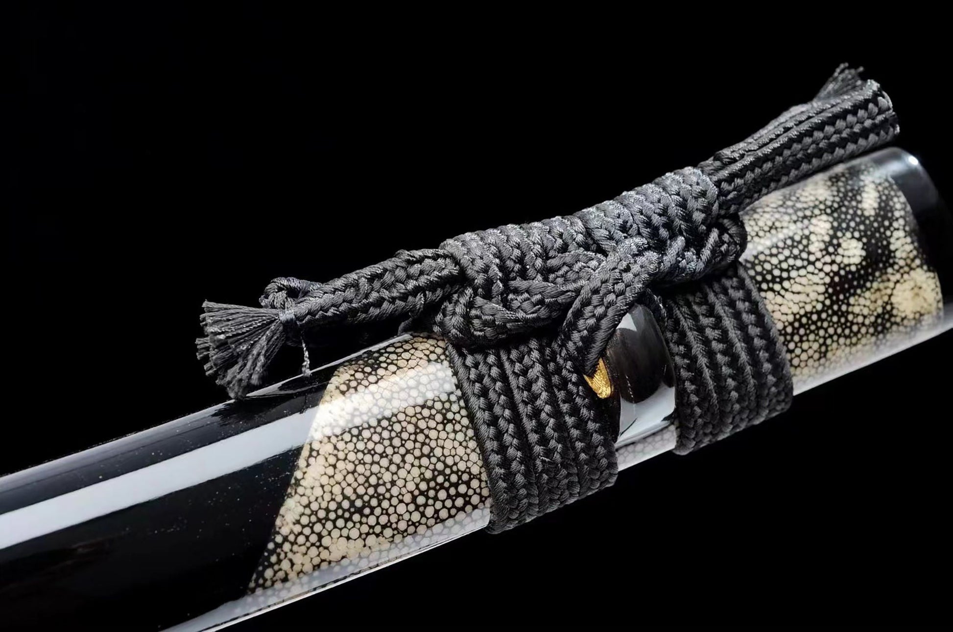 a close up of a knife with a rope on it