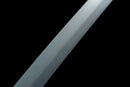 A close-up view of a metallic object, possibly a knife or blade, against a black background.