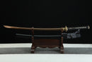 Sword on a wooden stand against a black background