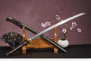 A close-up view of Moonswords Banrin Katana, with a brown handle and white accents, featuring intricate designs and patterns.