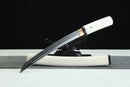 A white-handled Byakuga 白牙 Clay-Tempered T10 Steel Shirasaya Tanto is displayed on a black stand against a black background.