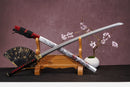 A close-up view of Moonswords Chi no bara Katana, with a black handle and red accents, featuring intricate designs and patterns.