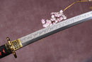 A close-up view of a Clay-Tempered T10 Steel blade against a textured background.