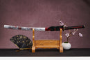 A close-up view of Moonswords Chi no bara Katana, with a black handle and red accents, featuring intricate designs and patterns.