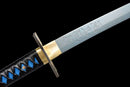 A close-up view of a Demon Slayer Nichirin Metal Katana with intricate blue and gold designs on the blade and handle.