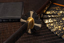 A photo of Moonswords Furin Kazan Katana in black, with a bronze guard, is shown against a dark, slatted bamboo mat background.