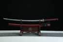 Fuun Katana with red shealth and black cording on a wooden stand against a black background