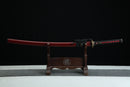 Fuun Katana with red shealth and black cording on a wooden stand against a black background