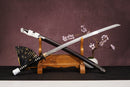 A close-up view of Moonswords Ghost of Yotei Atsu Katana, with a black handle and white accents, featuring intricate designs and patterns.