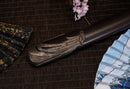 A close-up view of Moonswords Ghost of Yotei Katana with black shealth.