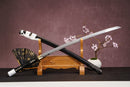 A close-up view of Moonswords Ghost of Yotei Katana, with a black handle and white accents, featuring intricate designs and patterns.