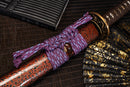 A close-up view of Moonswords Hi No Ko Katana with red shealth.