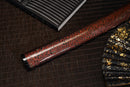A close-up view of Moonswords Hi No Ko Katana with red shealth.