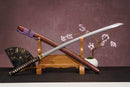 A close-up view of Moonswords Hi No Ko Katana, with a brown handle and white accents, featuring intricate designs and patterns.