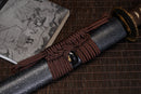 A close-up view of Moonswords Jato Katana with bronze guard, brown handle and black shealth.