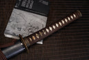 A close-up view of Moonswords Jato Katana with bronze guard, brown handle and black shealth.